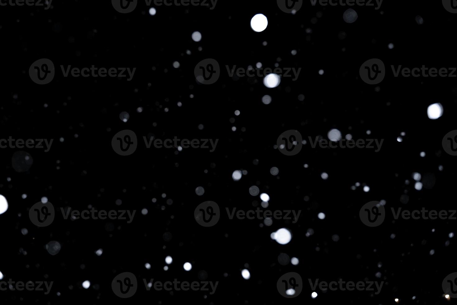 Element for winter design or overlay. Real snow over black background. photo