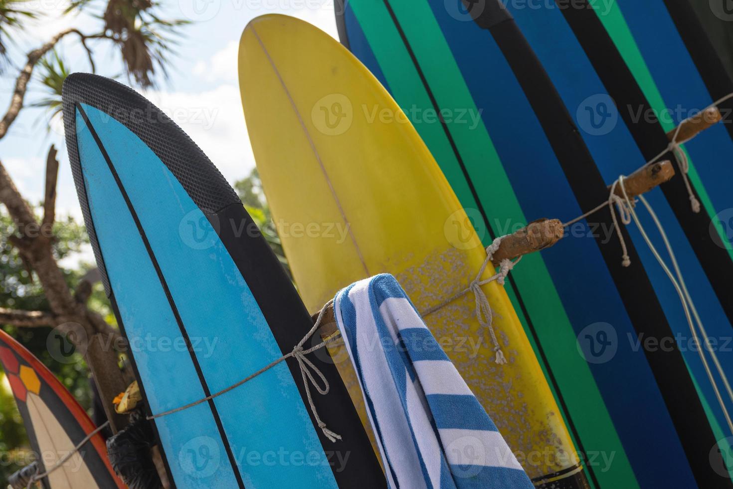 Stack of different surfboard for a rental on the beach photo