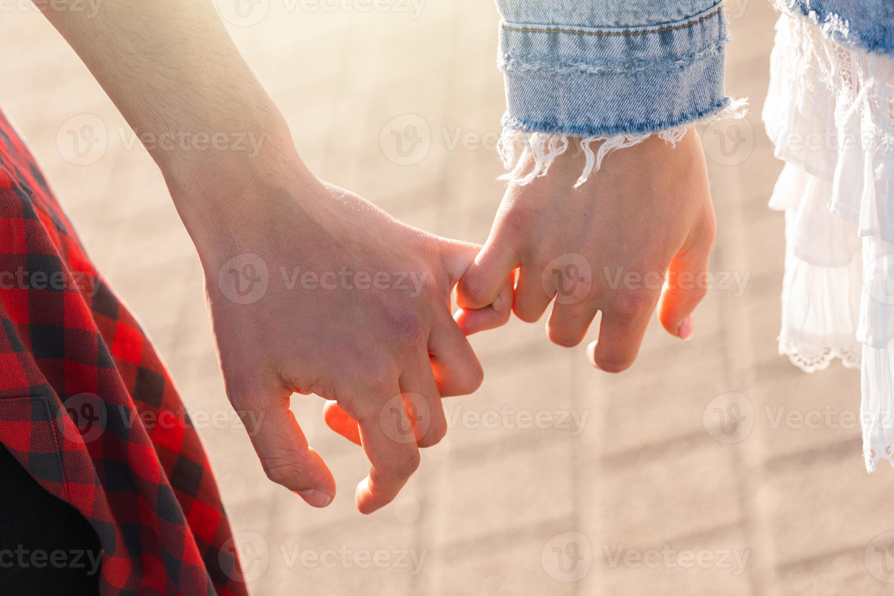Couple holding hands with a pinky grip 16248282 Stock Photo at Vecteezy