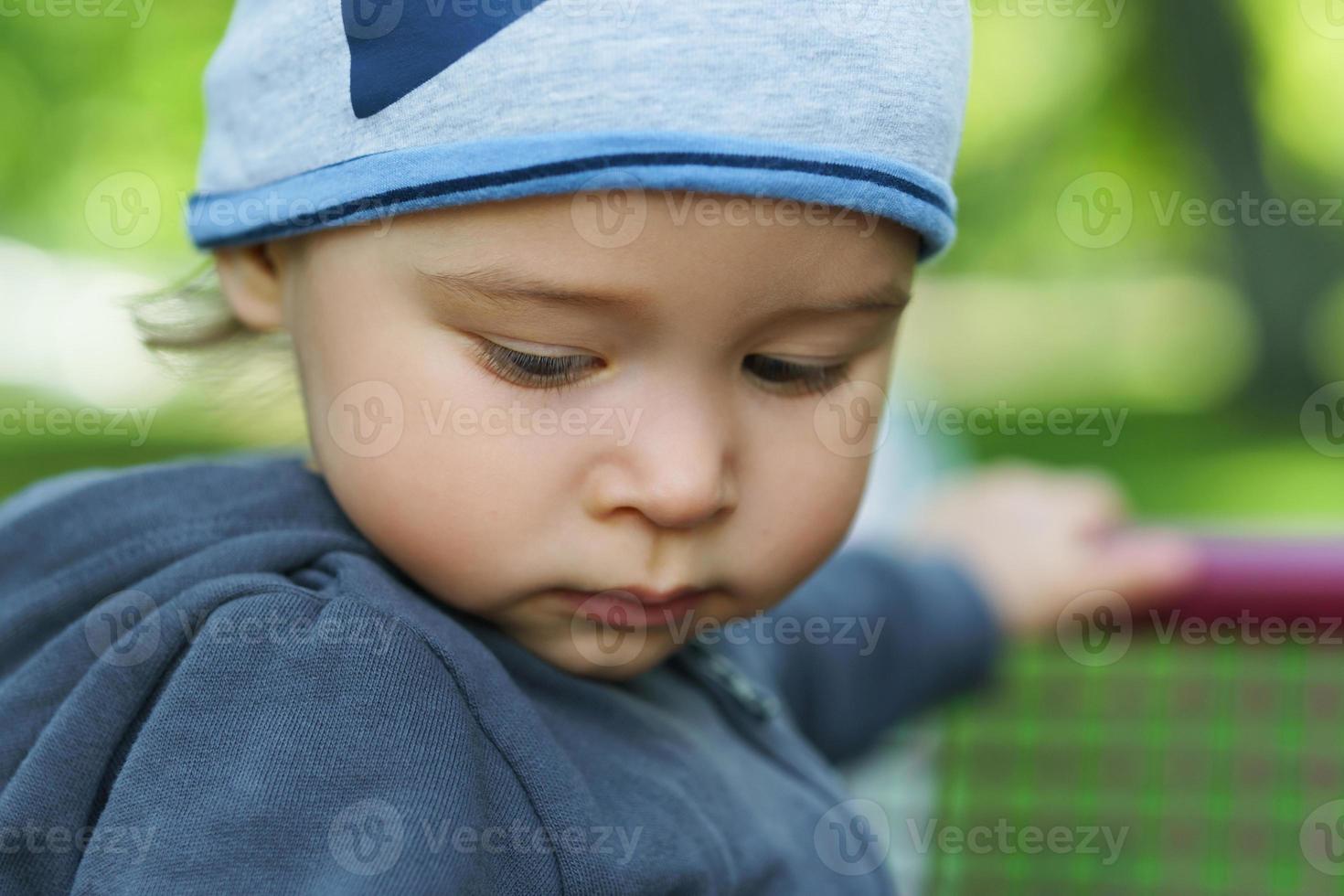 Cute little boy in a city park photo