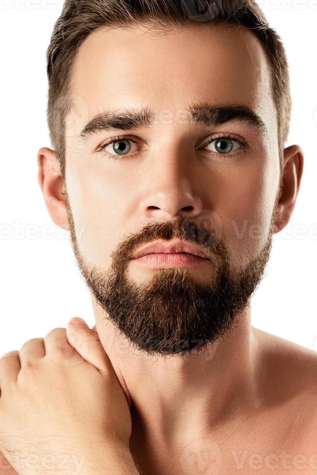 Young and handsome bearded man with smooth skin photo
