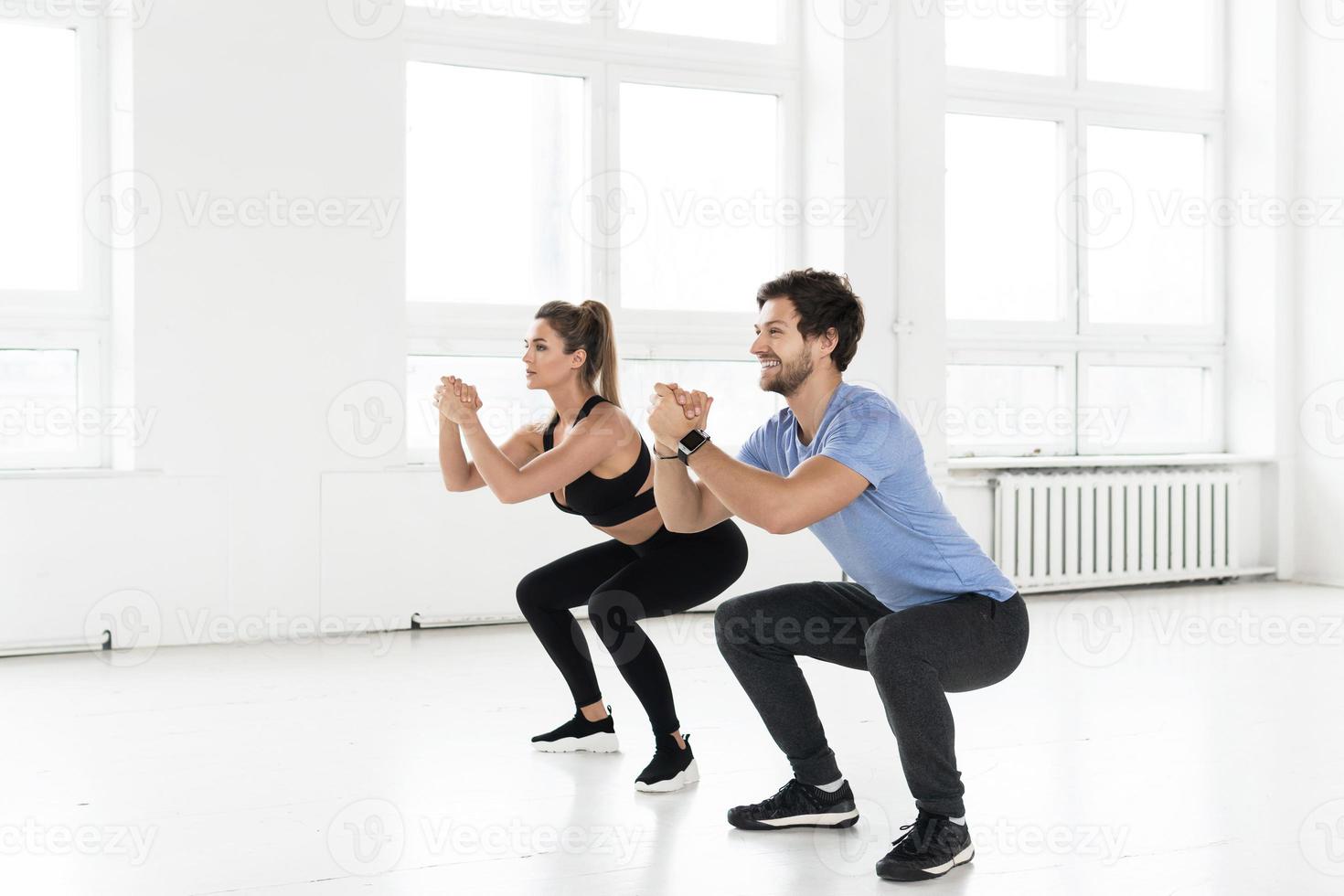 Fitness man and woman during workout with in the gym. photo