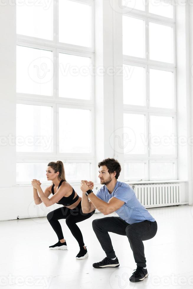 Fitness man and woman during workout with in the gym. photo