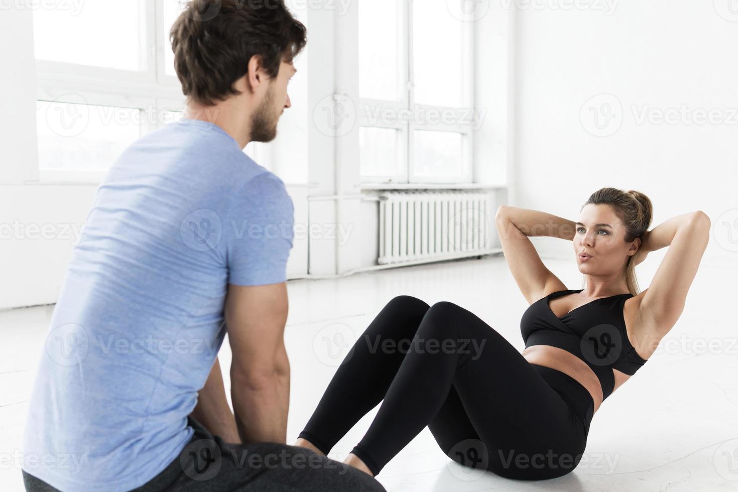 Fitness man and woman during workout with in the gym photo