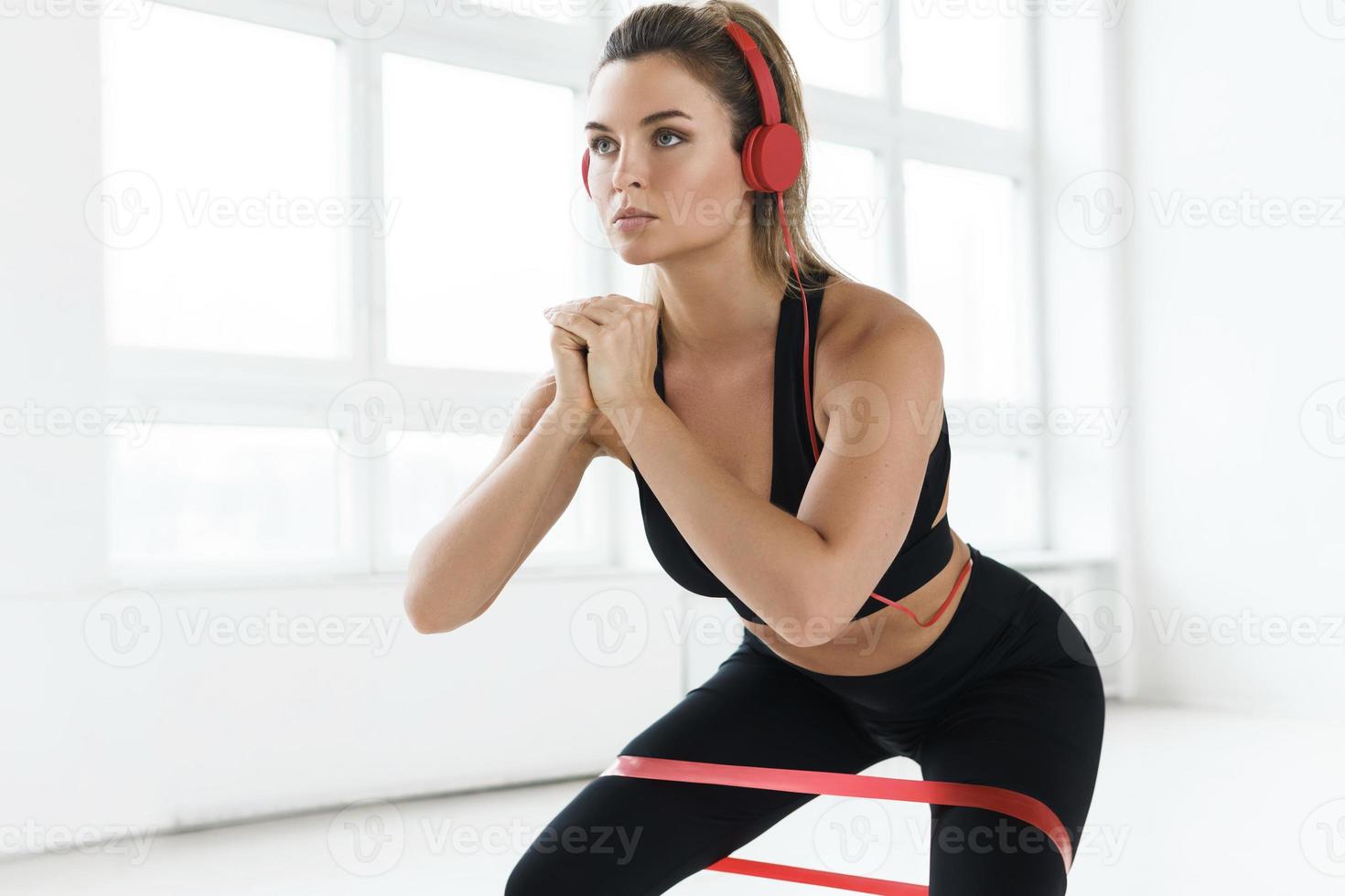 Young woman during her workout with a loop resistance band photo