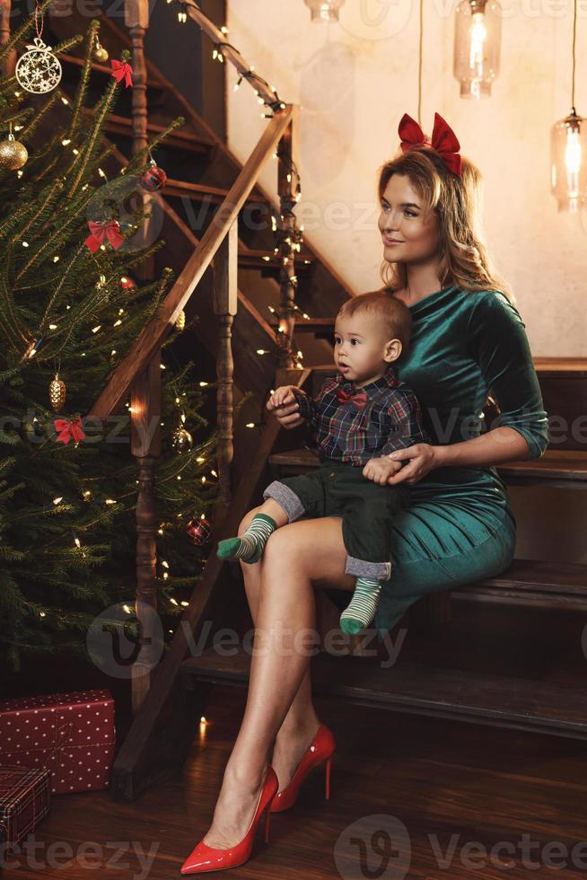 Happy mother and her cute little son are celebrating Christmas or New year. photo