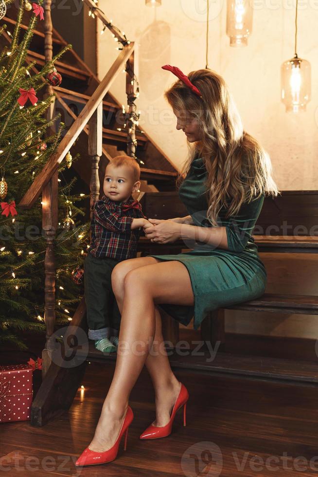 Happy mother and her cute little son are celebrating Christmas or New year. photo