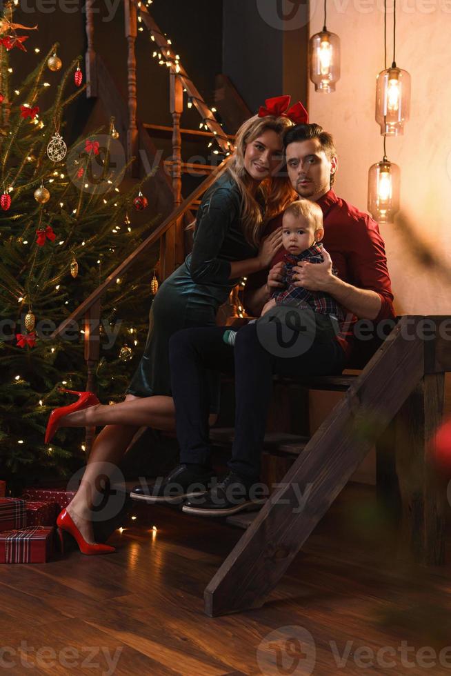 Young happy family are celebrating Christmas or New year. photo