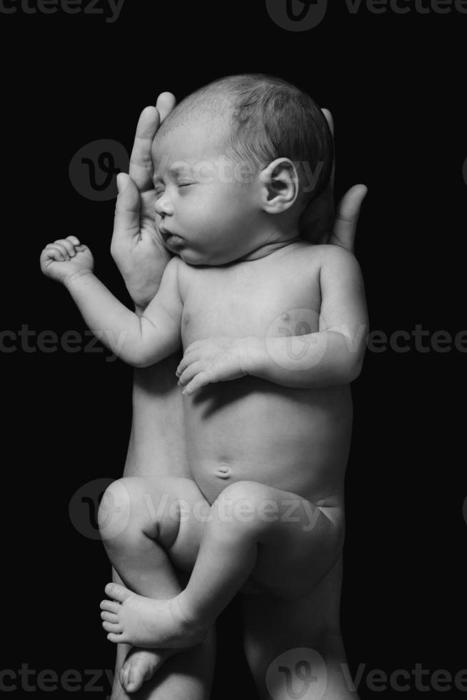 Cute newborn baby in the mother's hands photo