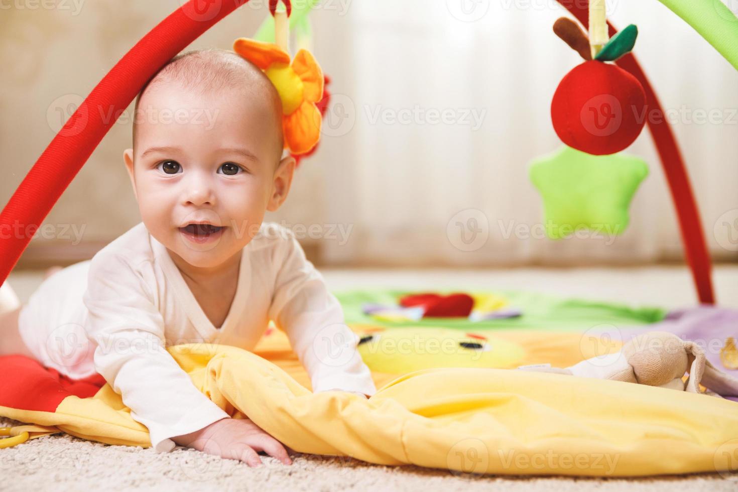 Cute baby is playing on the activity mat 16249511 Stock Photo at Vecteezy