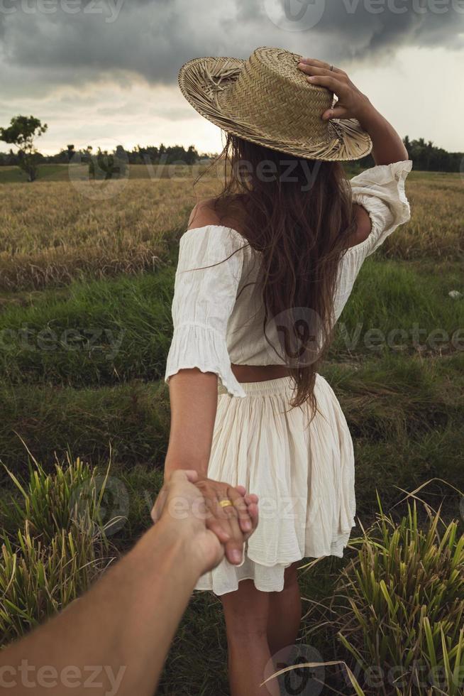 Couple holding hands in the rice field photo