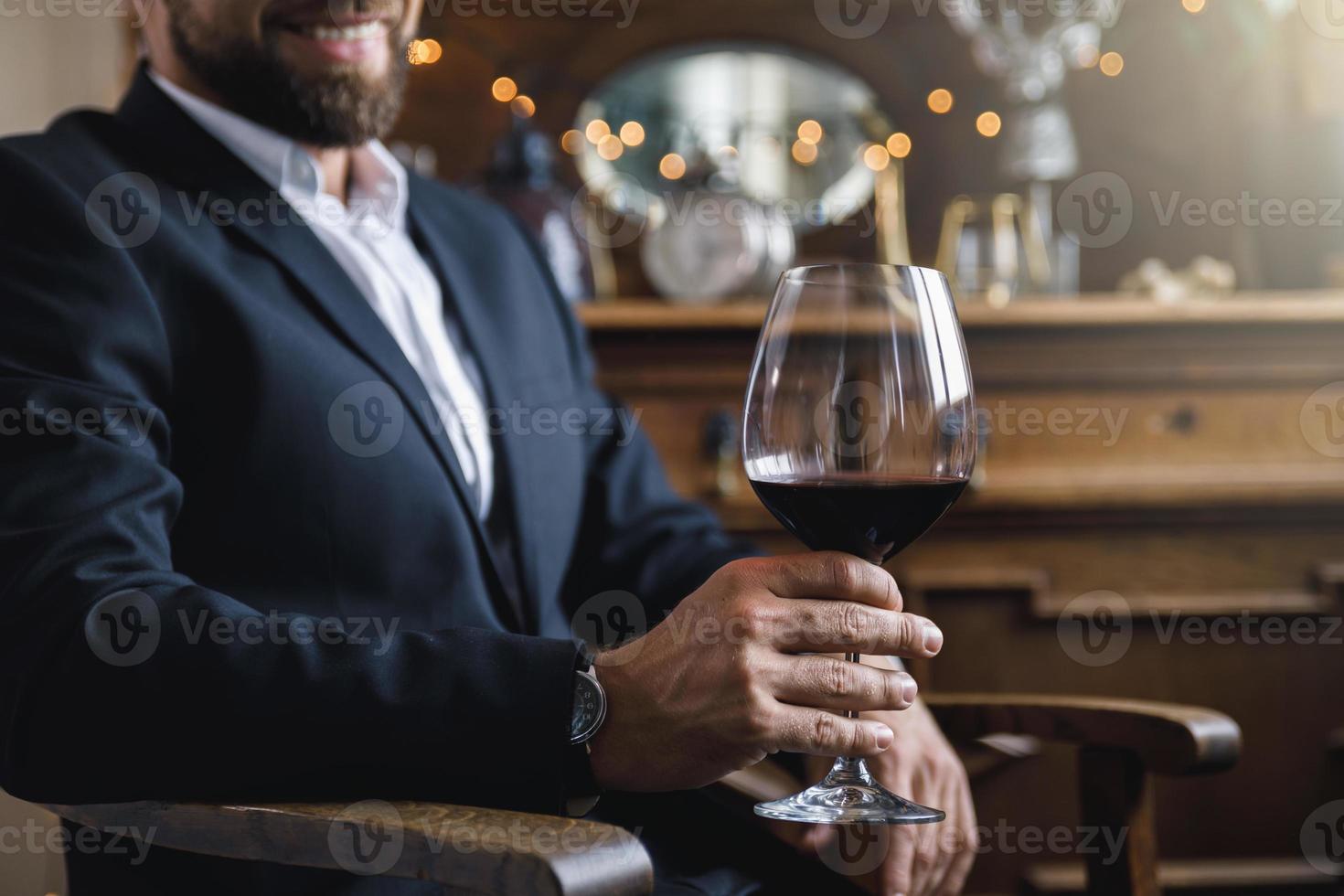 hombre con una copa de vino tinto foto