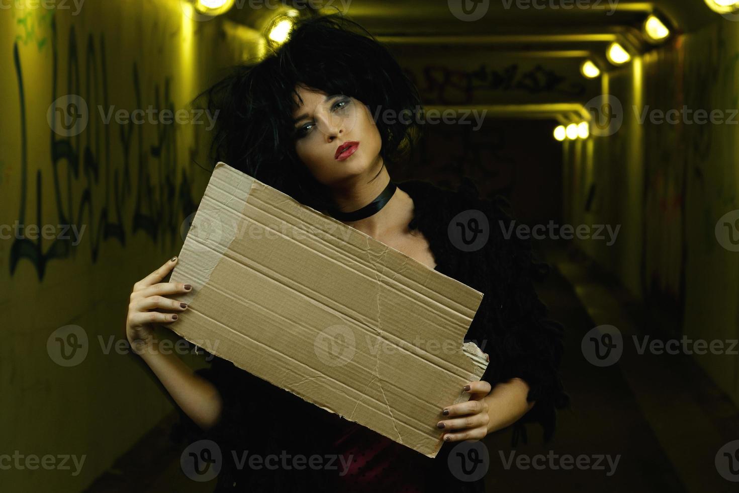 Strange and freaky woman with a piece of blank cardboard photo