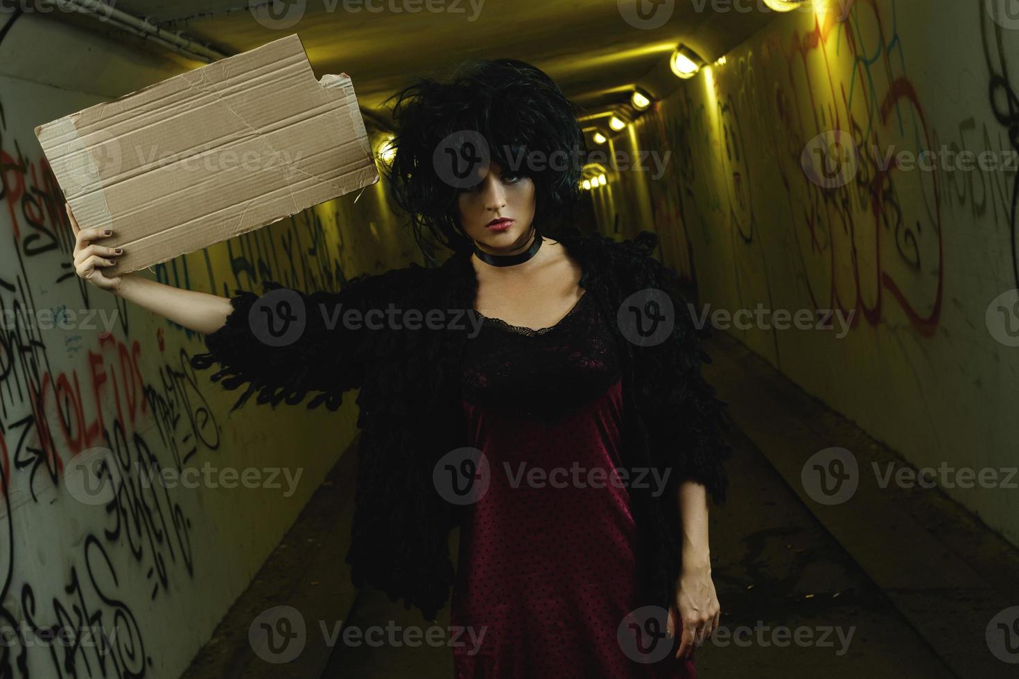 Strange and freaky woman with a piece of blank cardboard photo