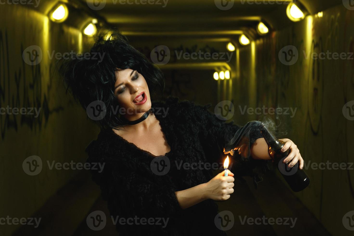 Freaky woman with a petrol bomb in her hands photo