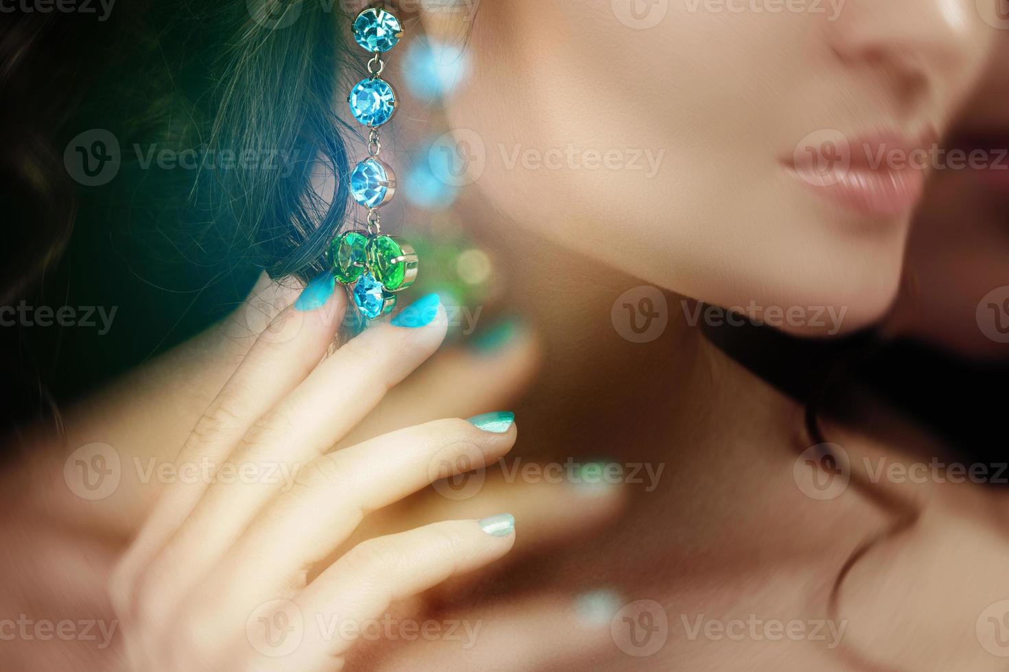 Woman wearing beautiful and expensive earrings photo