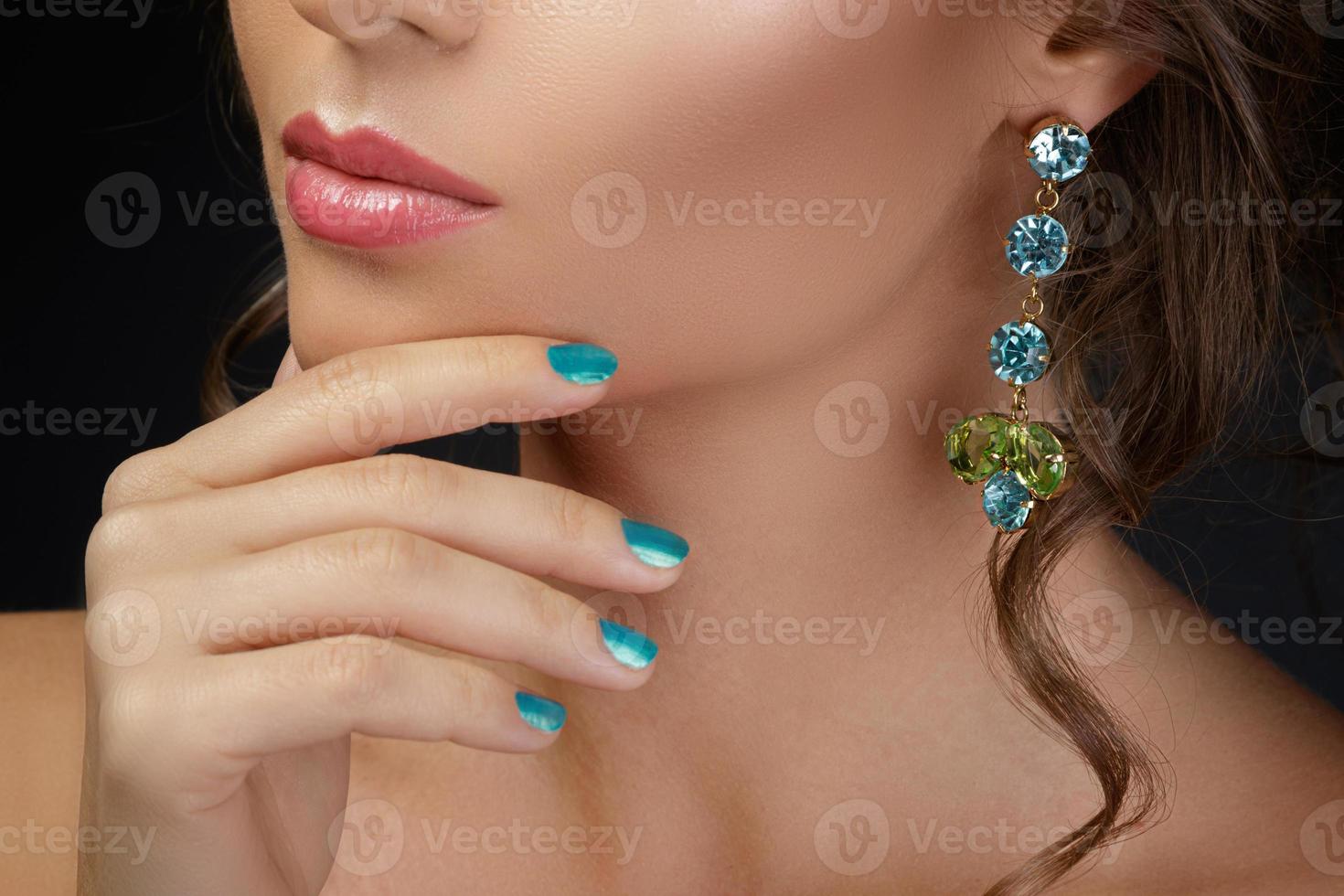 Woman wearing beautiful and expensive earrings photo