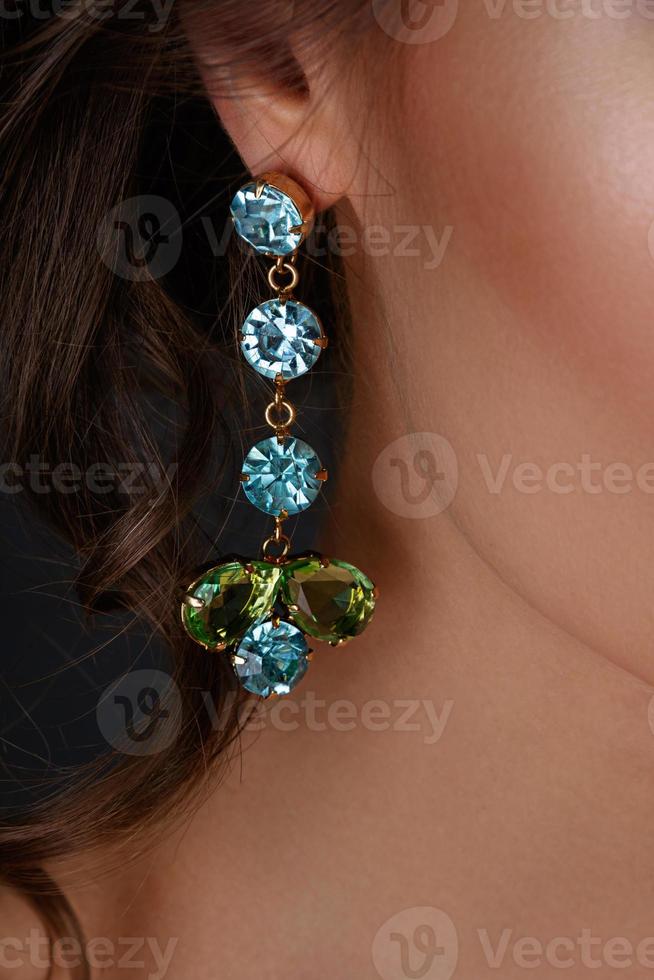 Woman wearing beautiful and expensive earrings photo