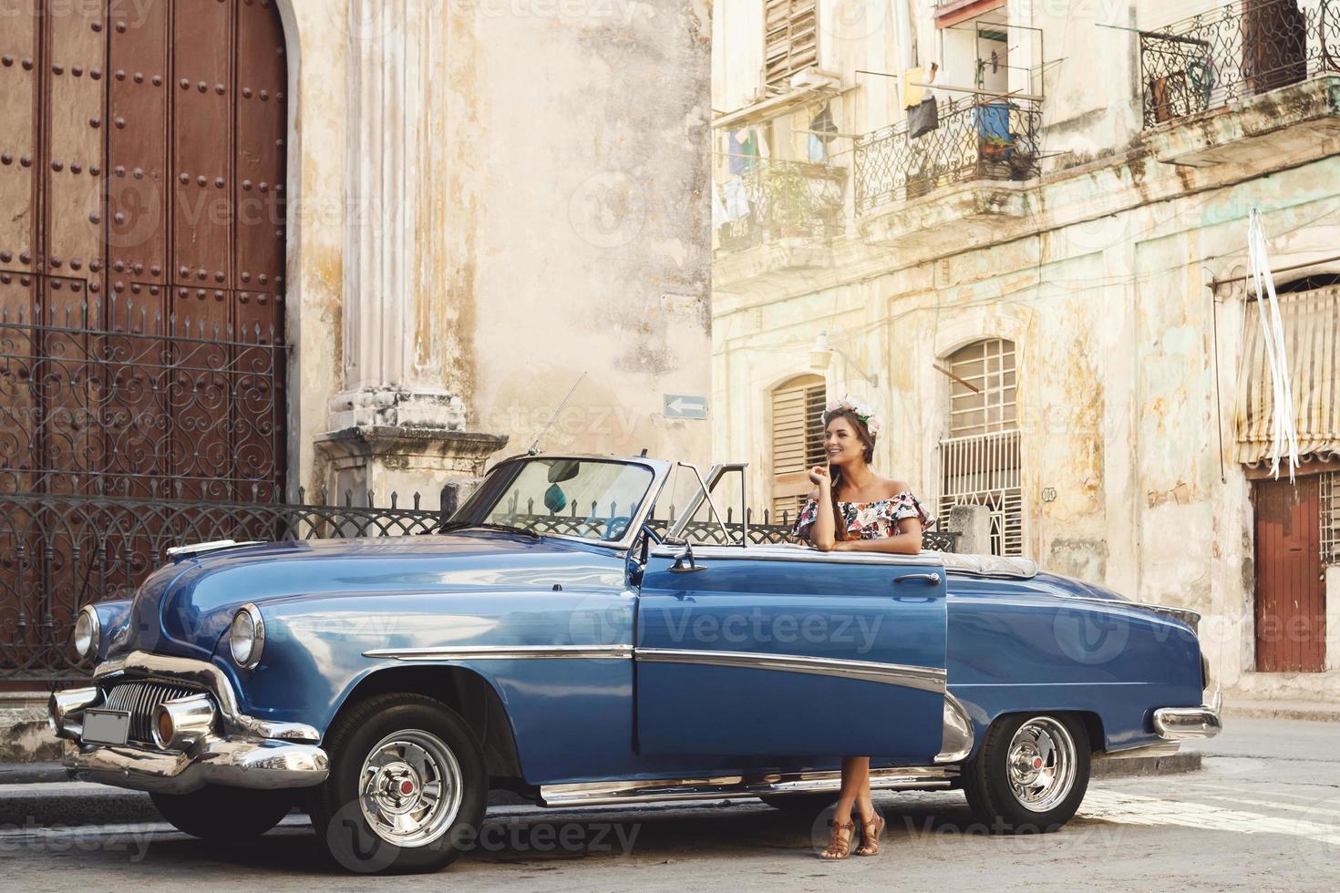 Beautiful woman driving a retro convertible car photo