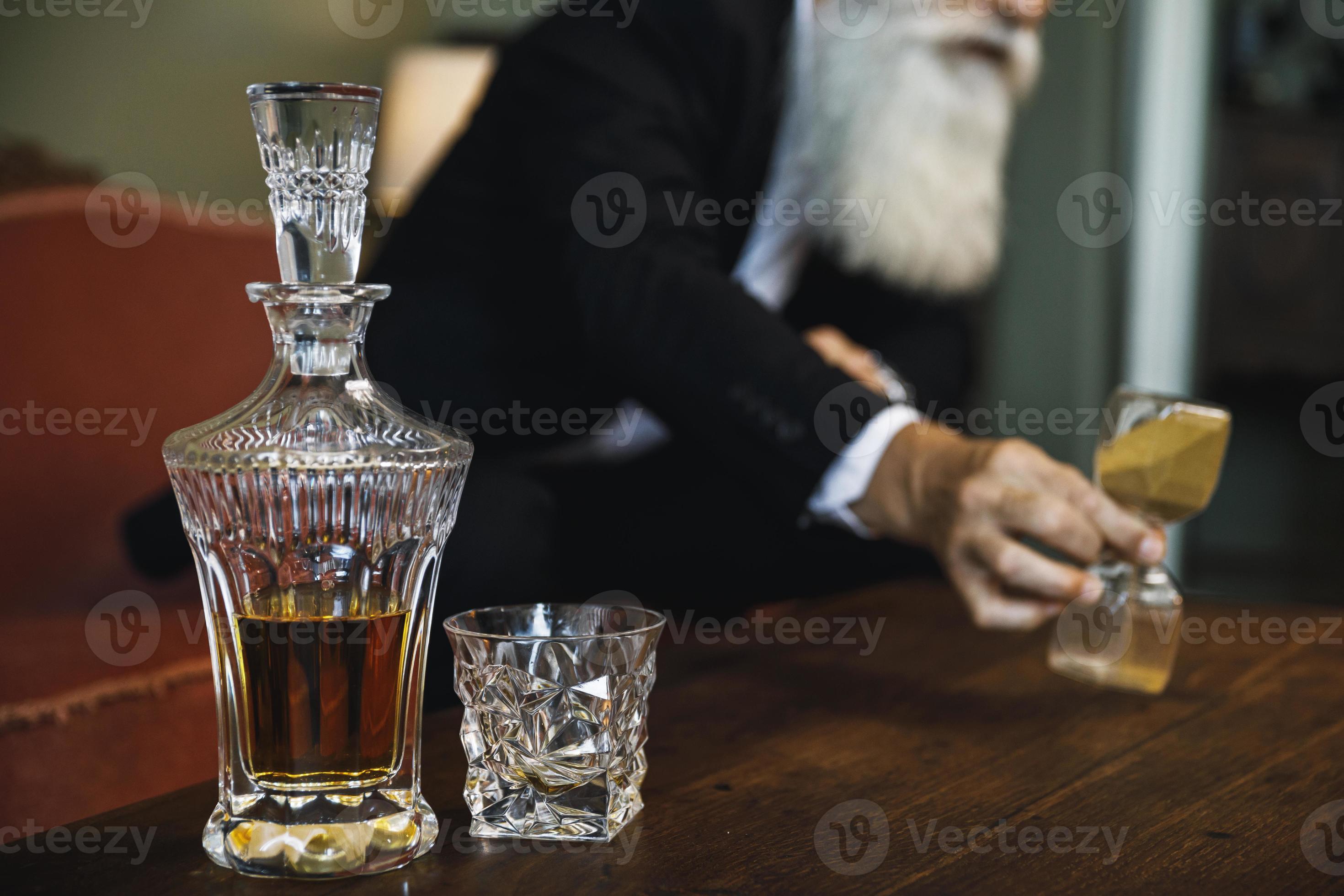 Decanter with expensive whiskey and senior man 16250475 Stock Photo at