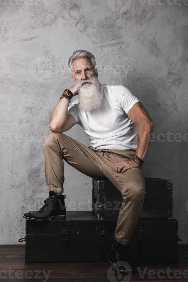 Handsome bearded senior man posing in studio photo