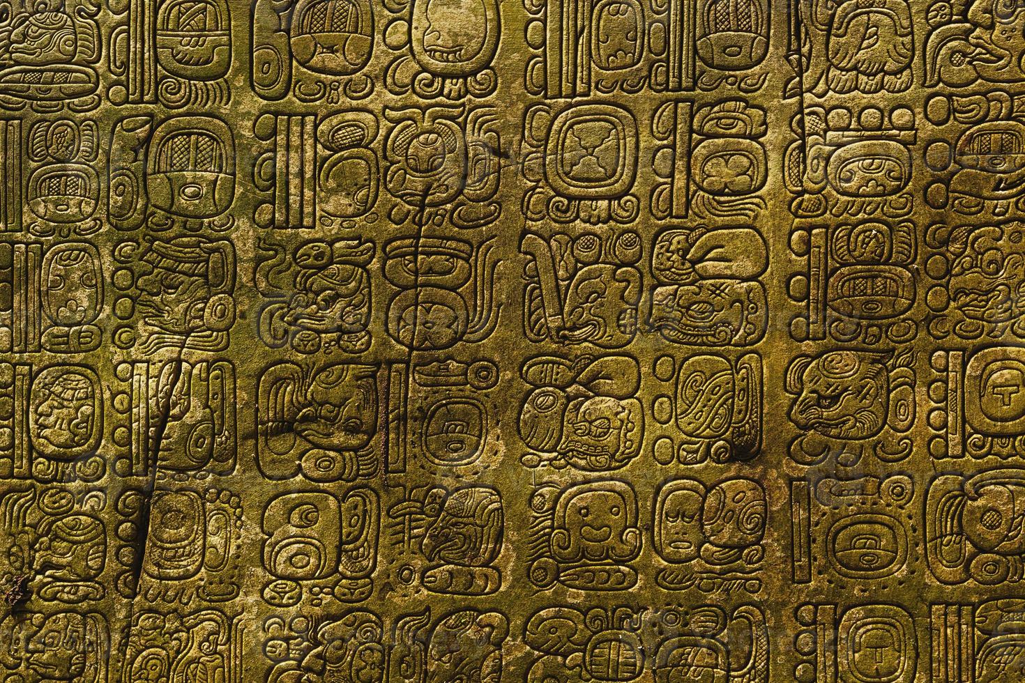 Ancient Maya script carved on the stone wall photo