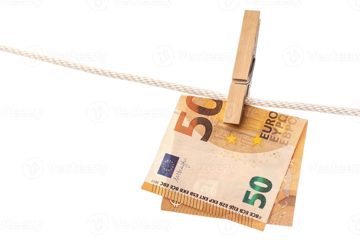 Euro banknote is hung on a rope with clothespin photo