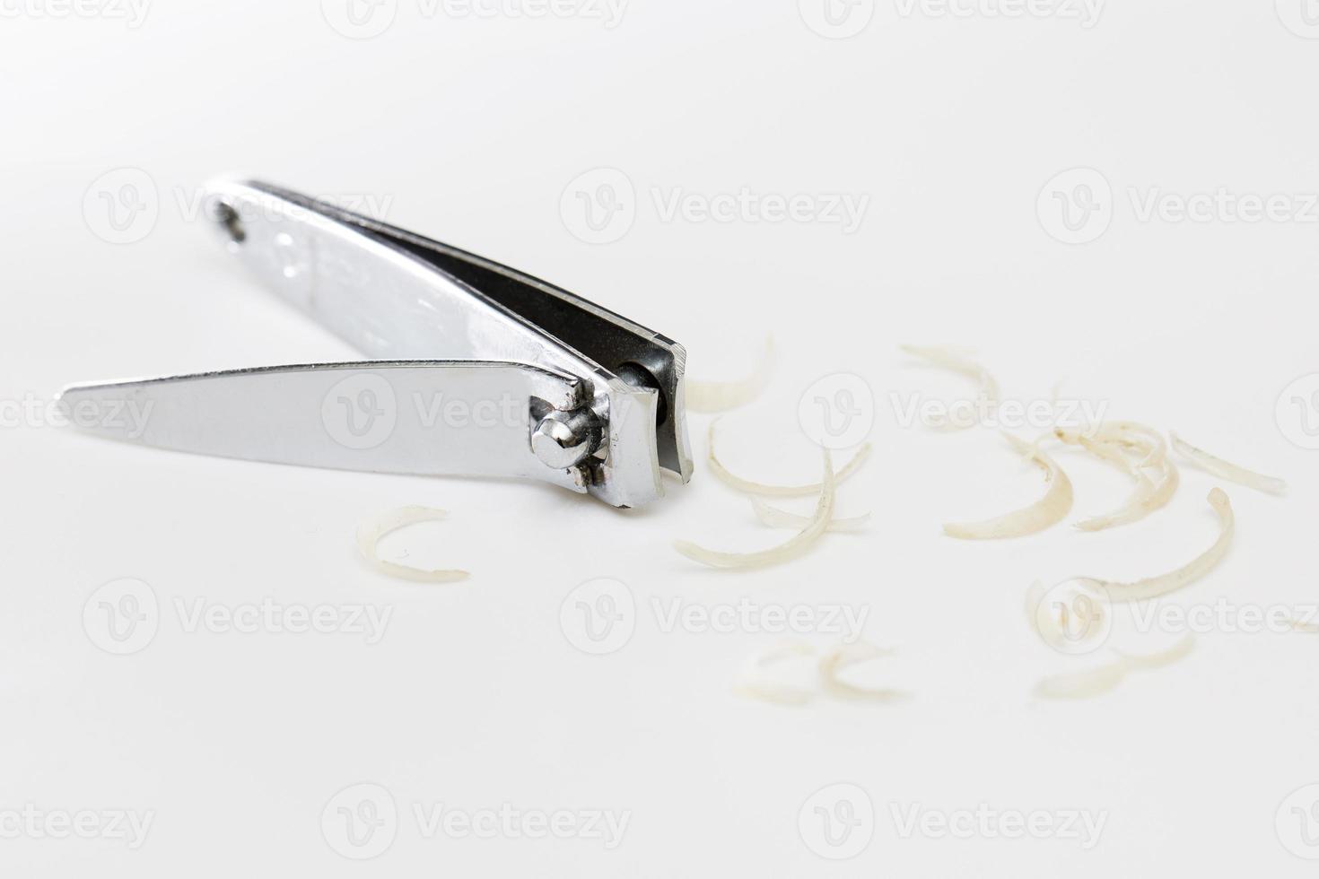Clipper and dirty nails on white background photo