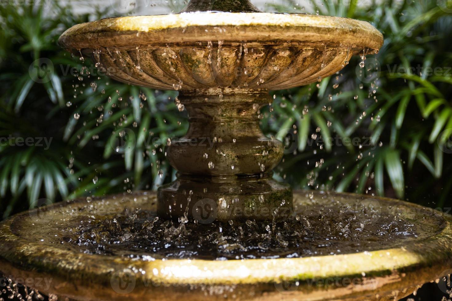 Background of old fountain with splashing water drops photo
