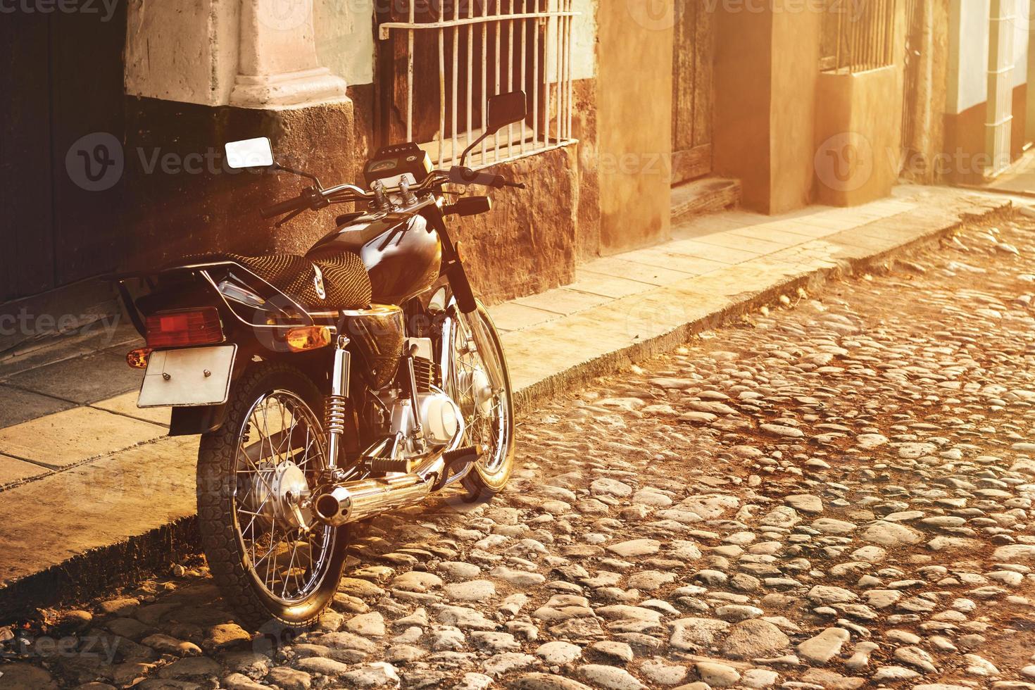 Retro motorcycle on the old city street photo