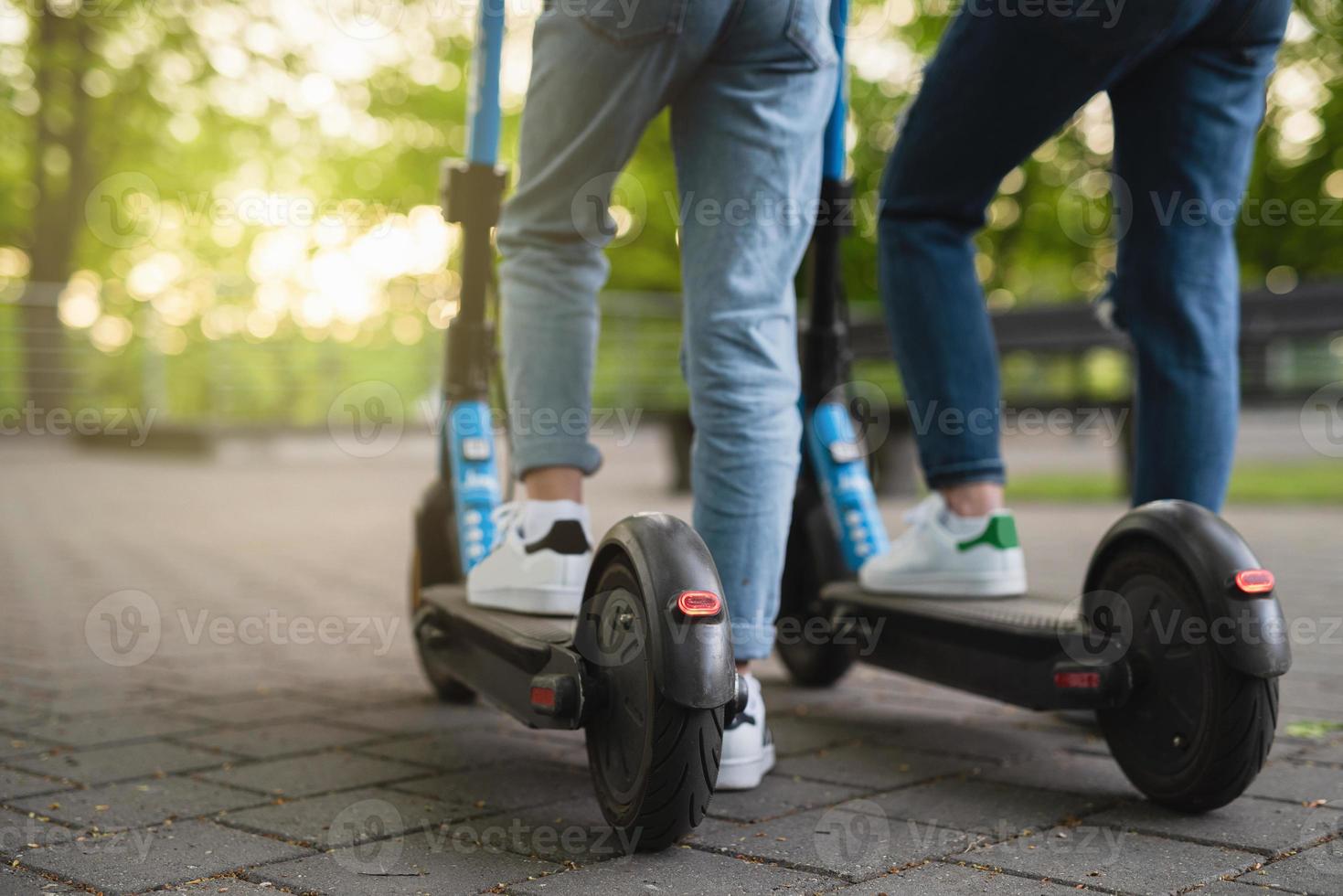 Mother and daughter riding electric scooters photo