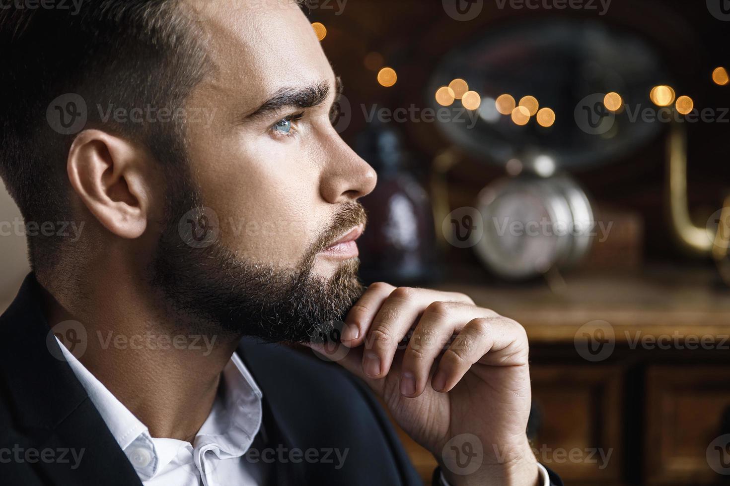 Handsome bearded man wearing black classic suit photo