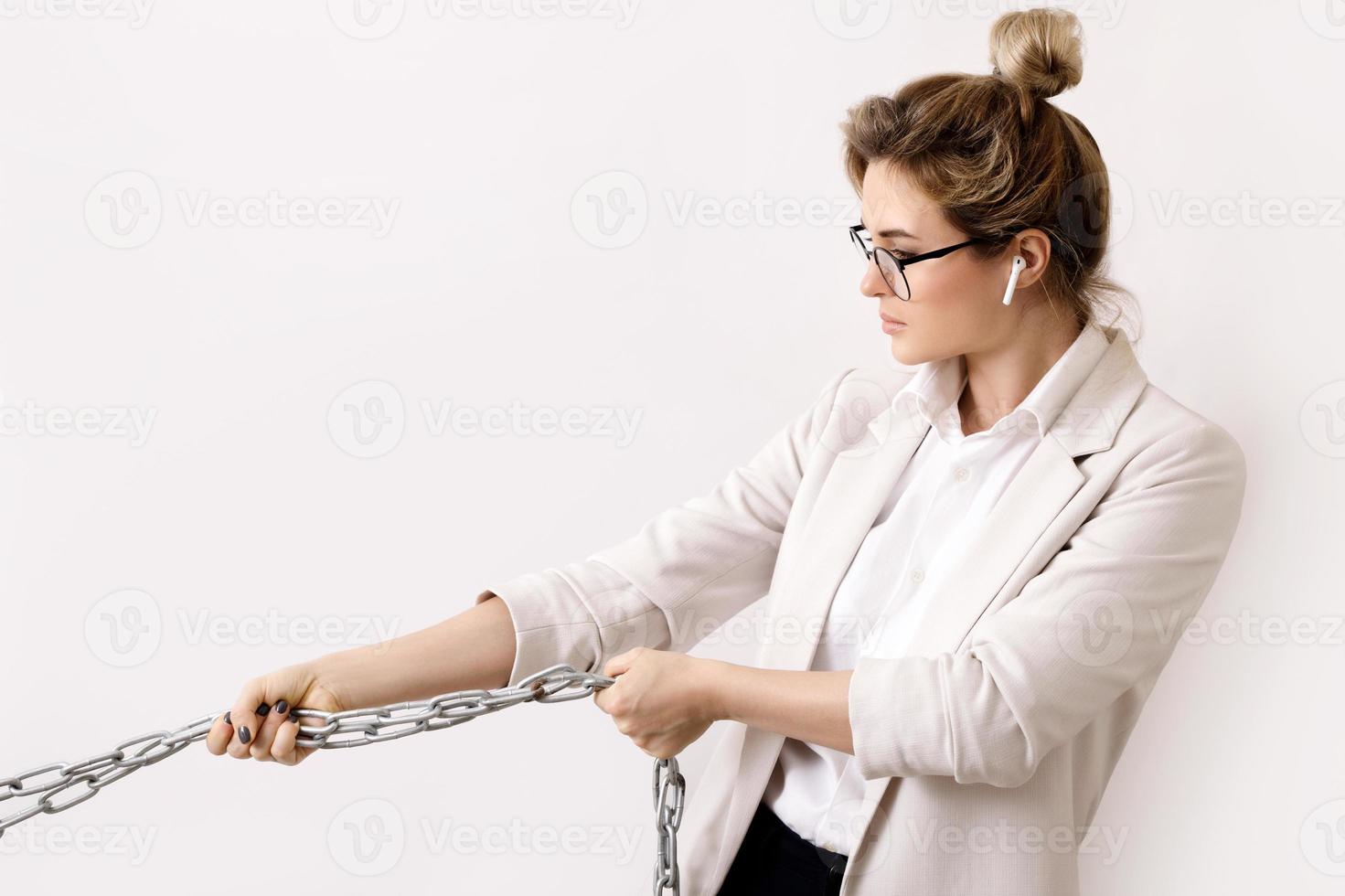 Tired business woman is pulling the chains photo