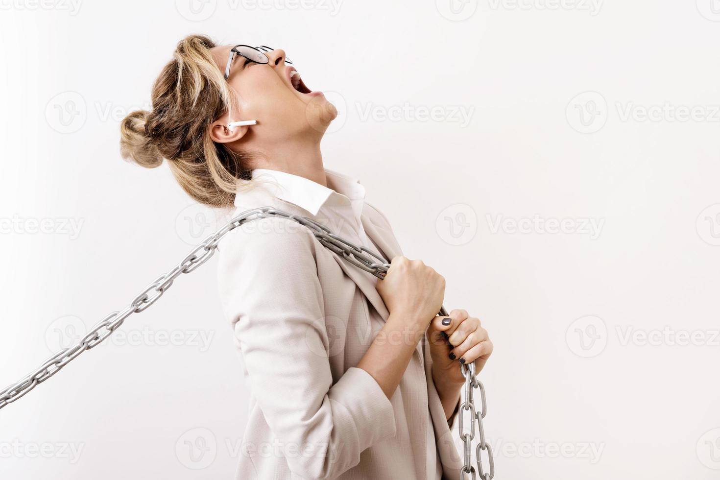 Tired business woman is pulling the chains photo
