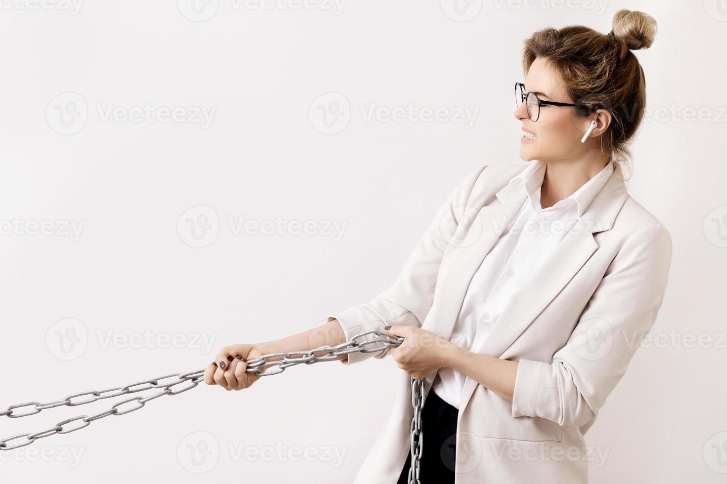 Tired business woman is pulling the chains 16251767 Stock Photo at Vecteezy