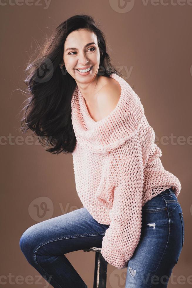 Portrait of beautiful middle aged woman wearing warm woolen sweater photo