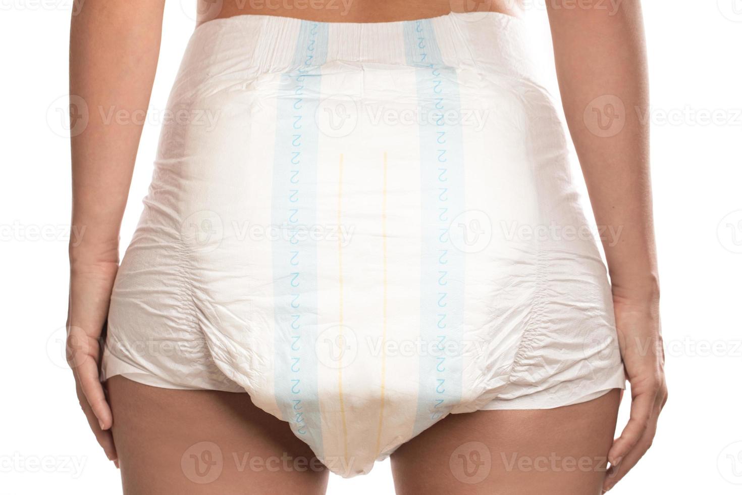Woman wearing adult diaper against white background. photo