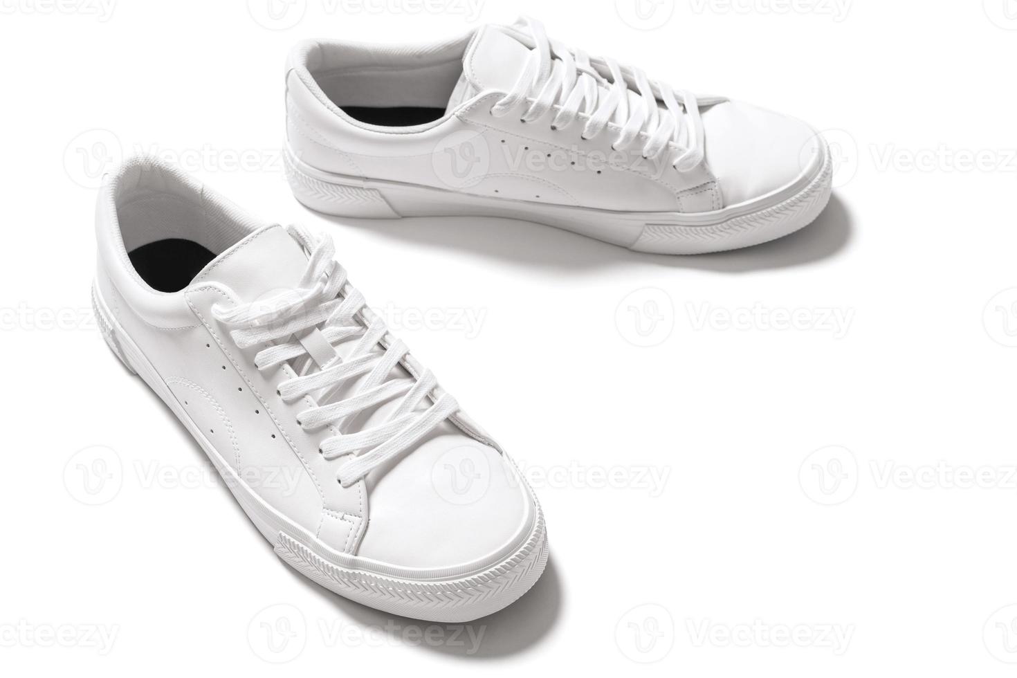 Pair of white leather trainers on white background photo