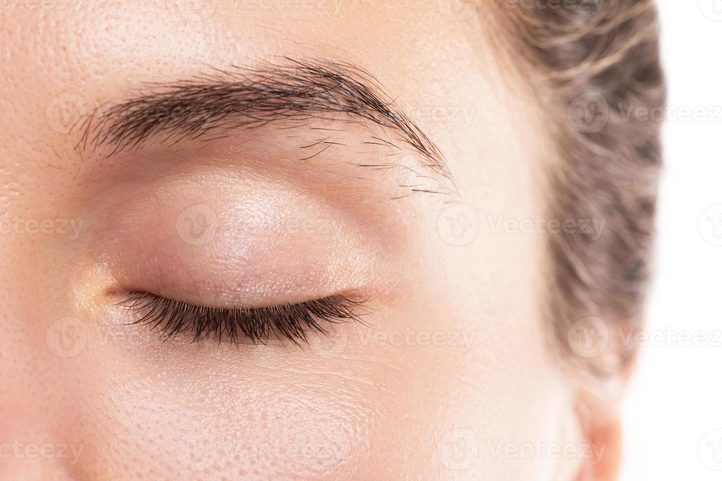 Closeup of female face with unkempt and unruly eyebrow photo