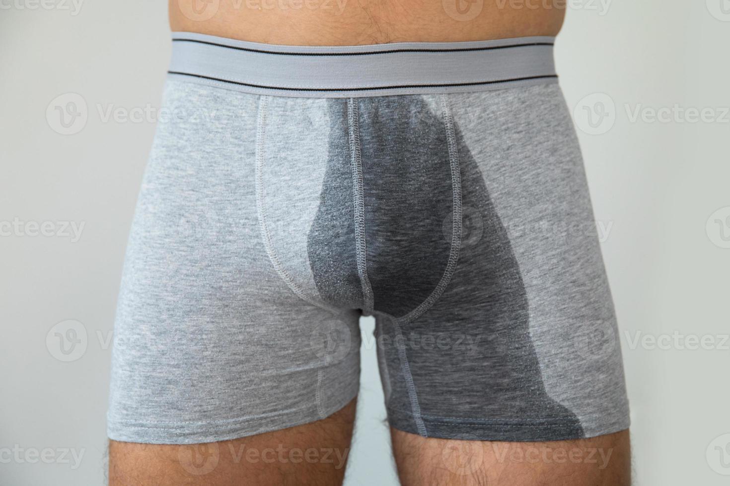 Man with wet briefs because of urinary incontinence photo