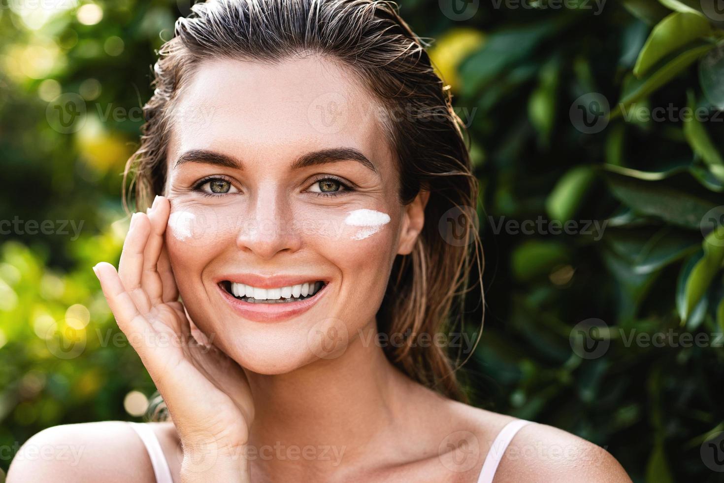 Beautiful woman with moisturizing cream under her eyes 16252827 Stock