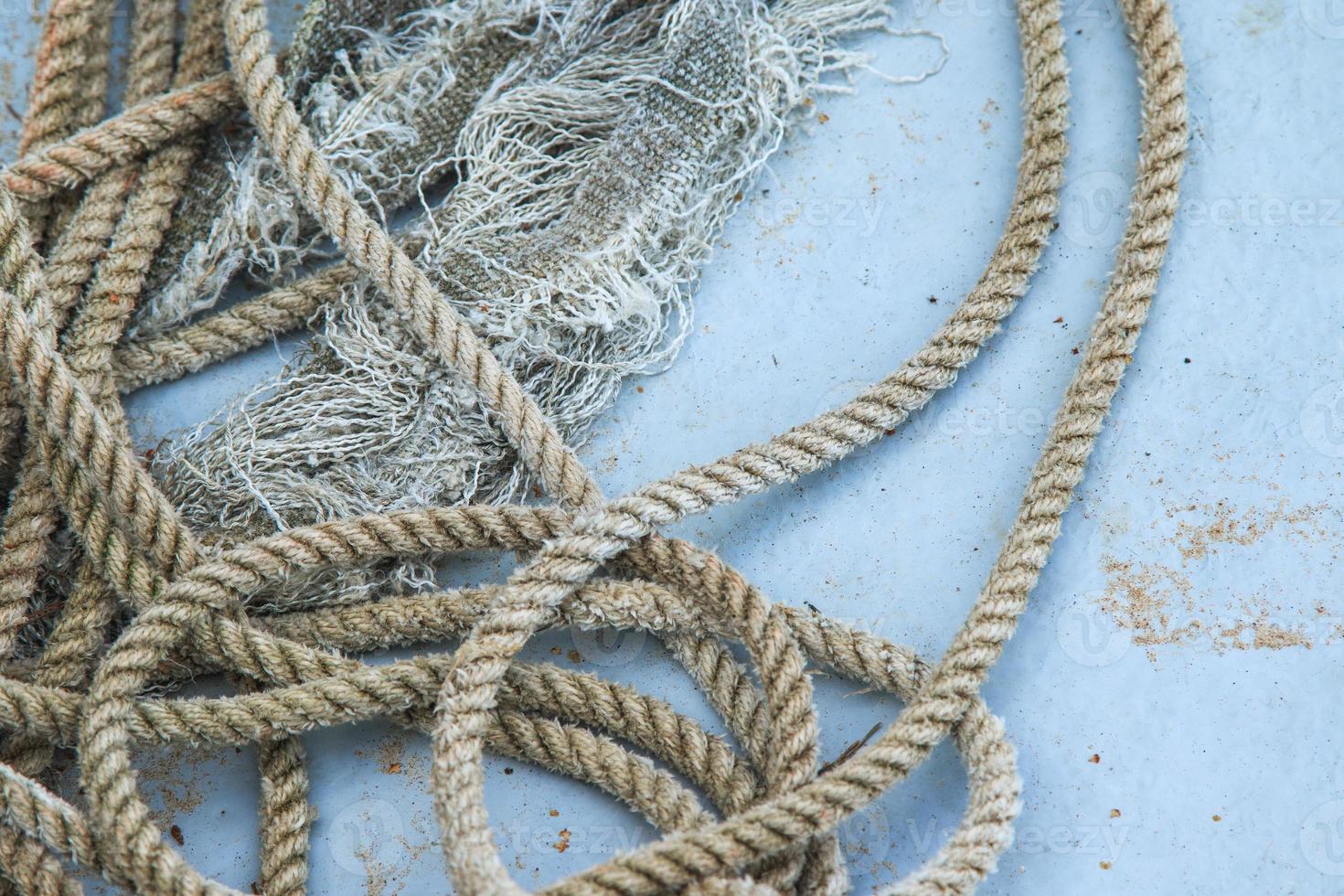 Closeup of coil of nautical rope on fishing boat hull. 16256182