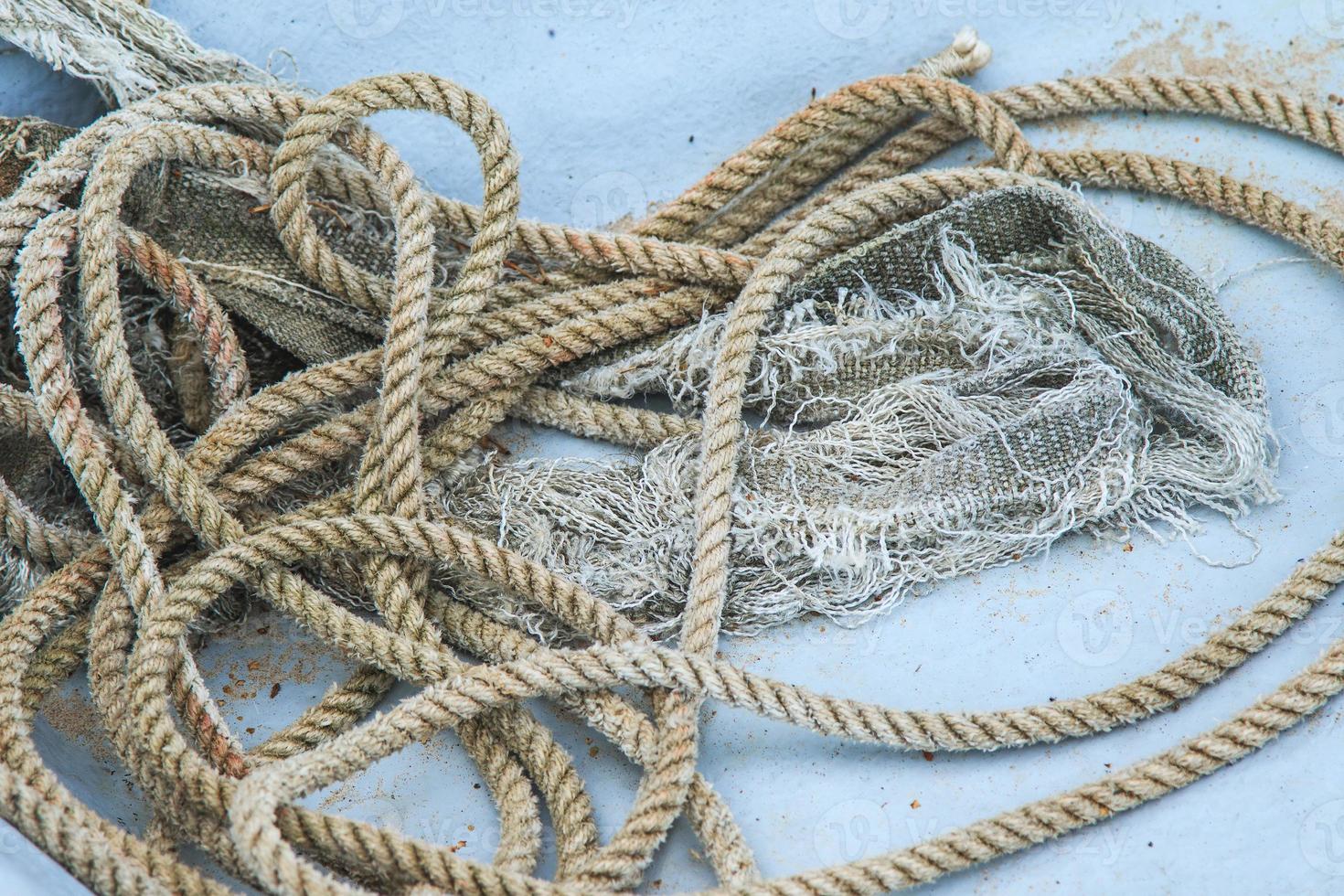 Closeup of coil of nautical rope on fishing boat hull. photo