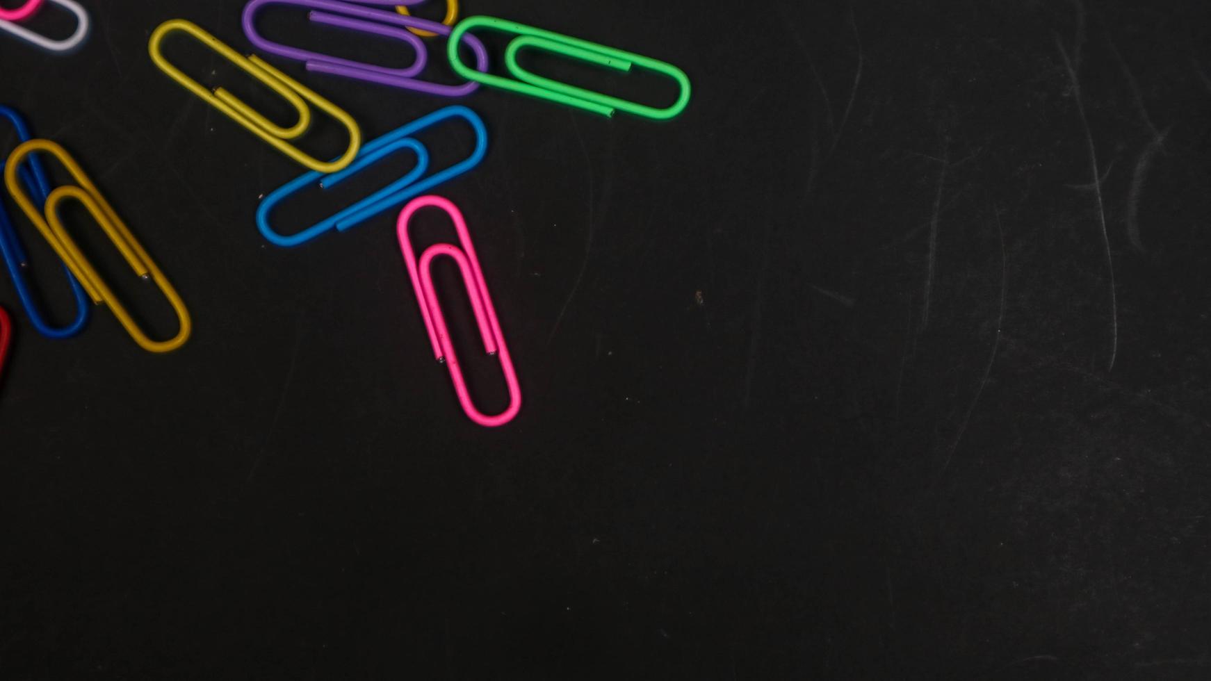 Paper clip isolated on a black background photo