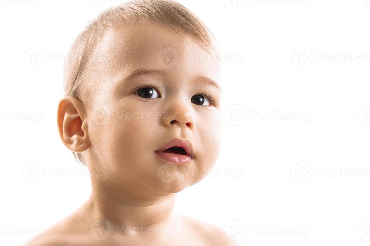 Closeup shot of curious little boy face. photo