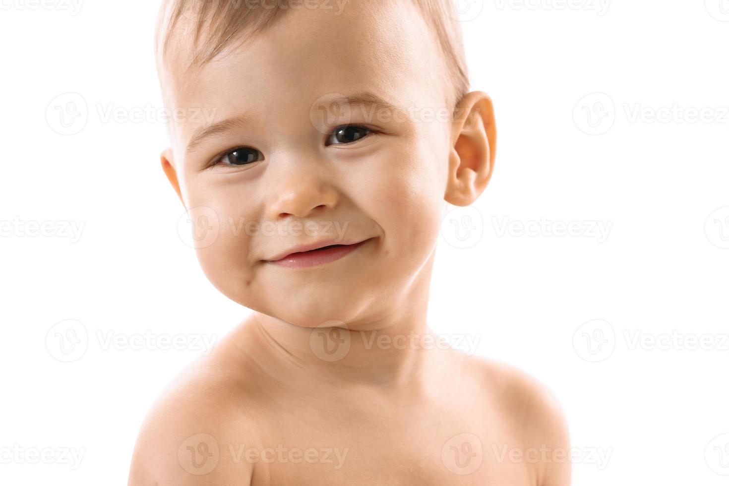 Closeup shot of smiling little boy face. photo