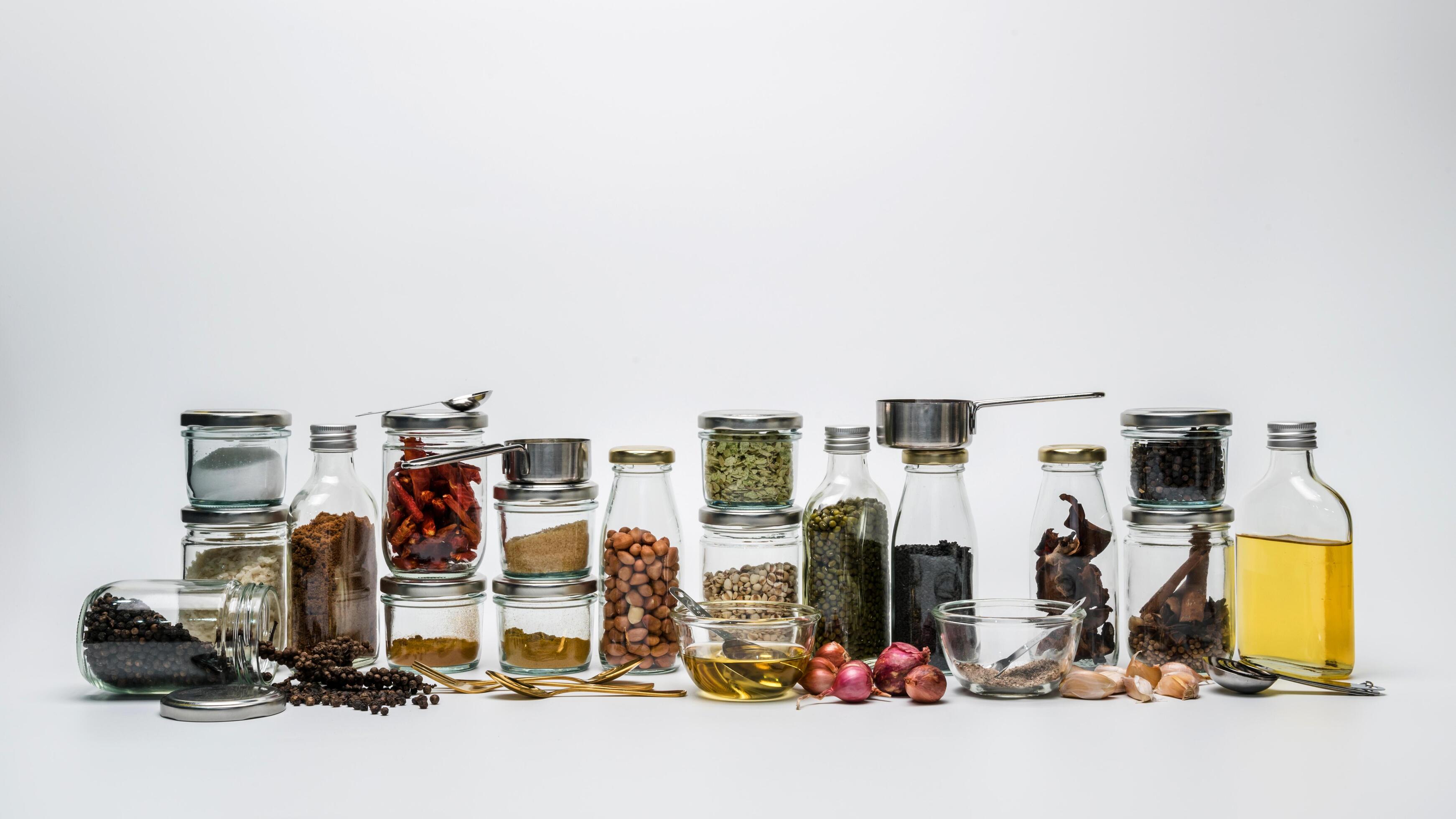 Assortments of spices. Row of spice jars assorted and herb seeds in jars on white background