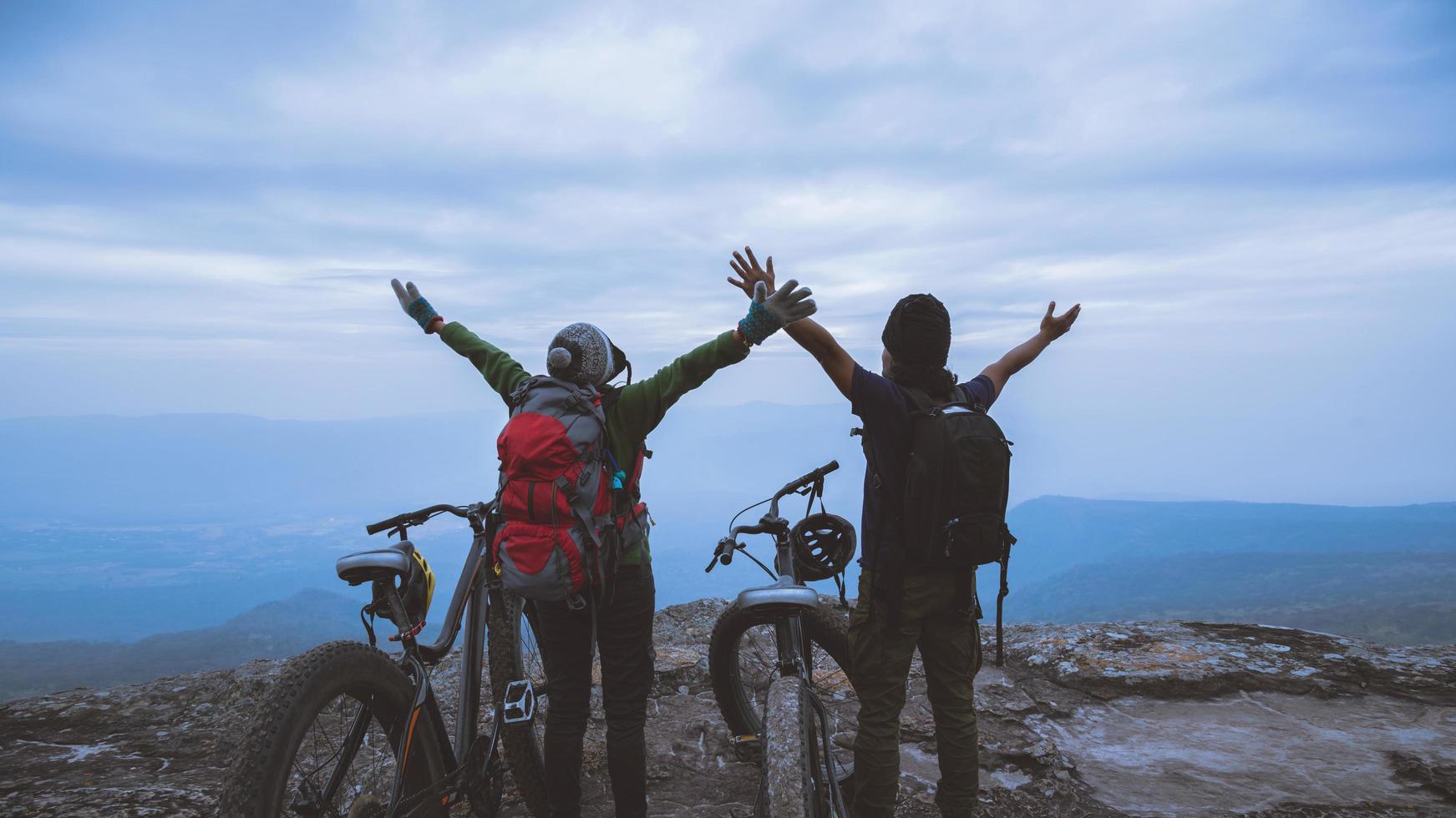 Asian lover women and men Travel Nature. Travel relax ride a bike Wilderness in the wild. Standing on a rocky cliff. travel Thailand photo