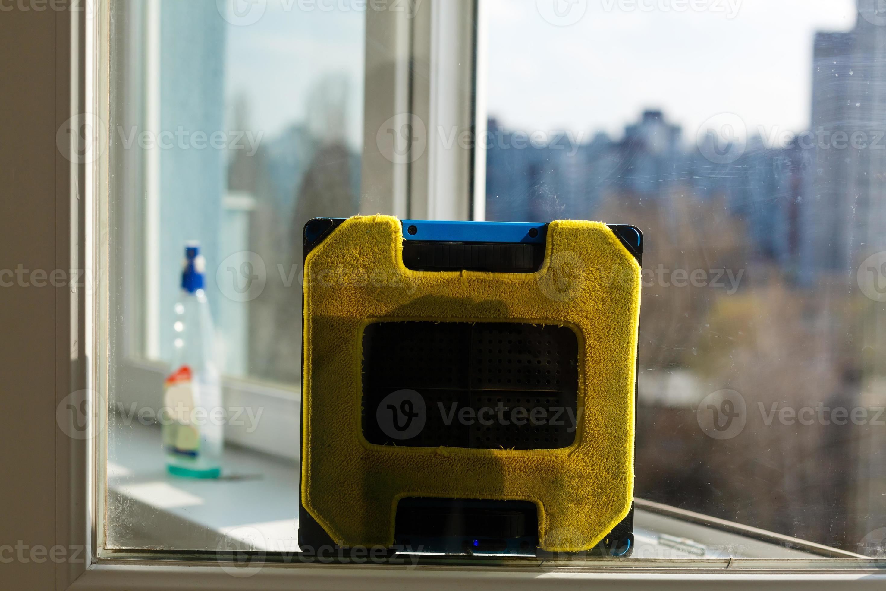 Robot window cleaner work on dirty window. Cleaning the house with