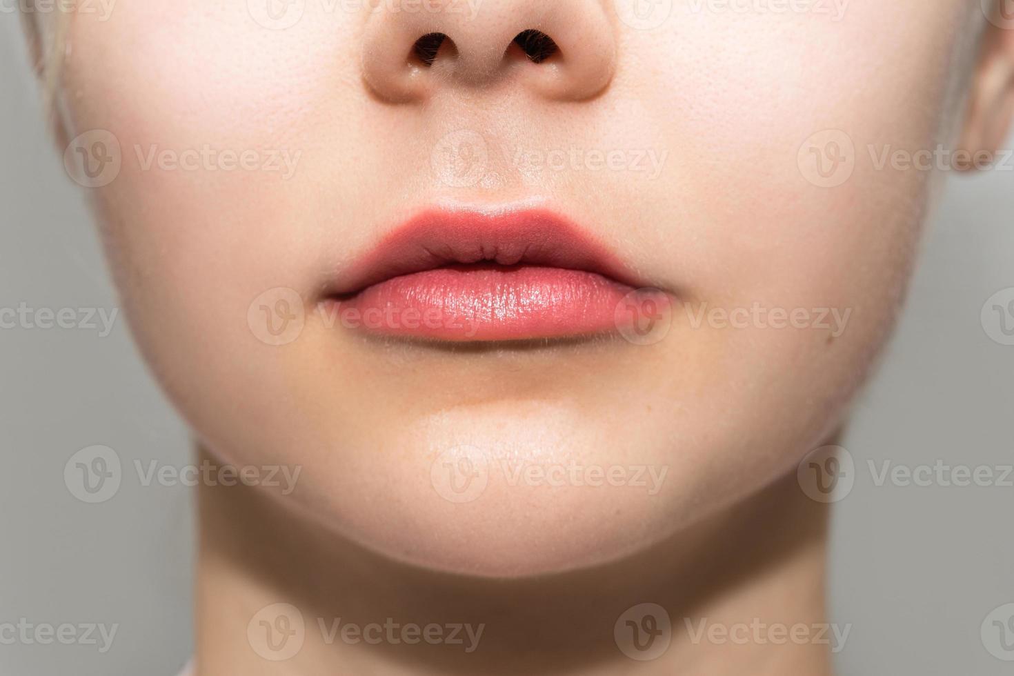 Female lips after permanent makeup lip blushing procedure photo